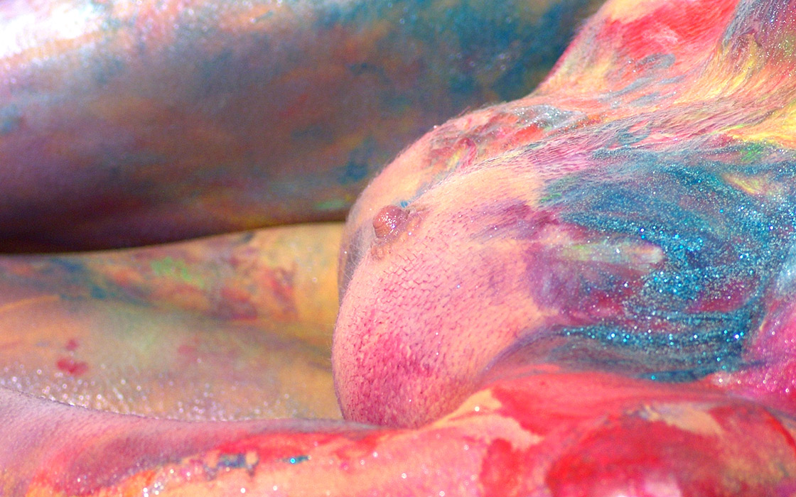 small breasted woman covered in paint